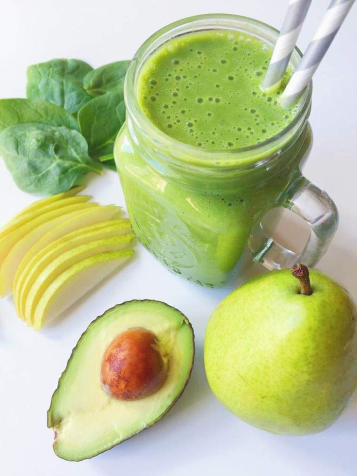 an avocado, banana, and spinach smoothie on a white surface