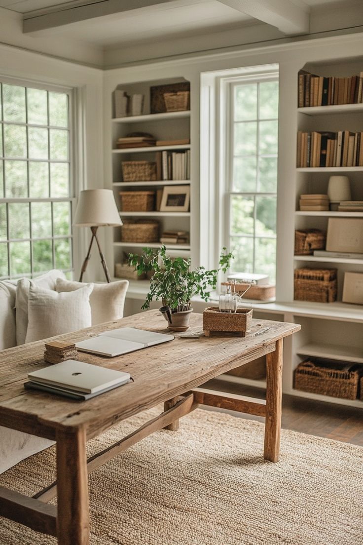 a living room filled with furniture and bookshelves next to a window covered in lots of windows