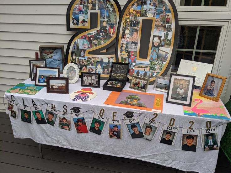 a table with pictures and photos on it in front of a number twenty five sign