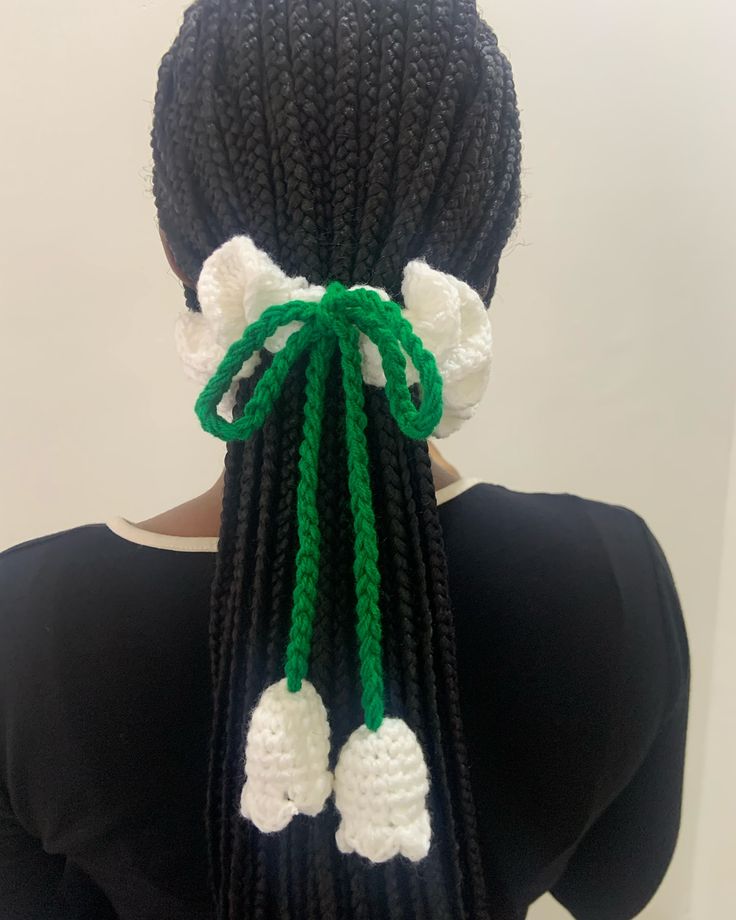 the back of a woman's head with crochet braids