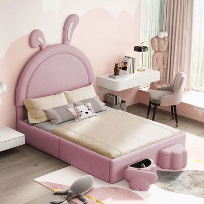 a bedroom with pink walls and furniture in the room, including a bed that has an animal head on it