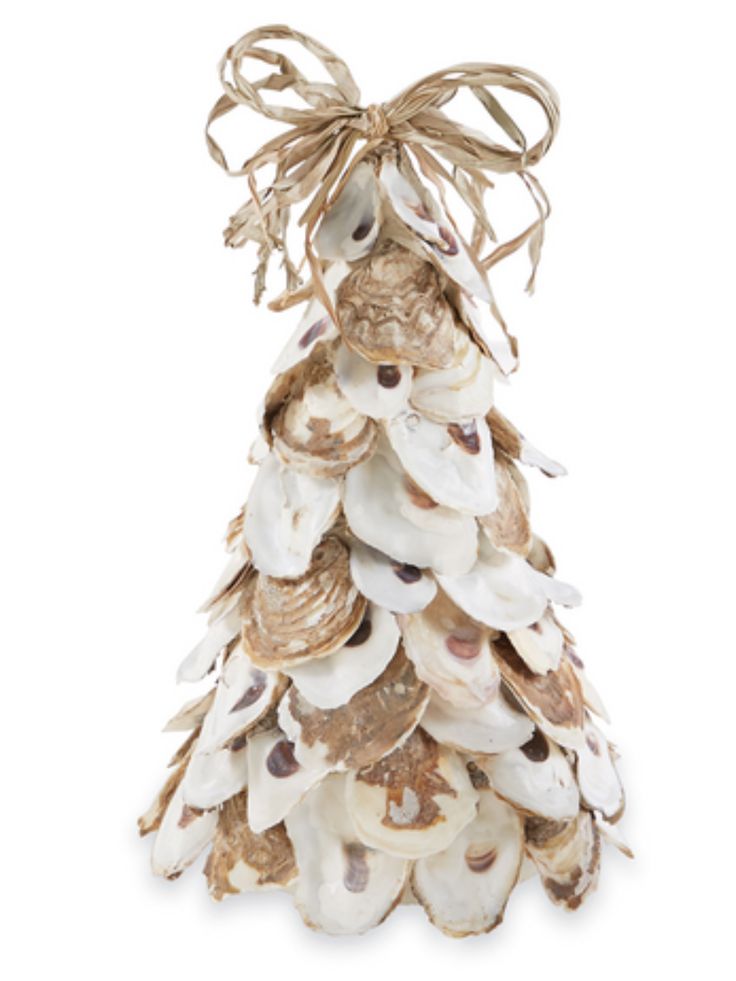 a christmas tree made out of seashells with a bow on it's head