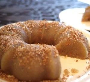 a bundt cake is sitting on a plate with powdered sugar sprinkled around it