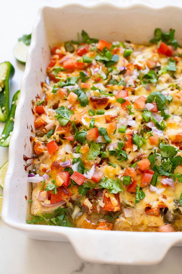 a casserole dish filled with vegetables and cheese