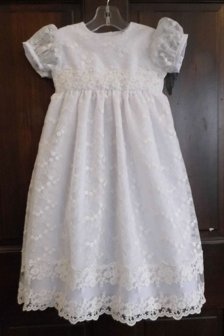 WOW! Cordelia is an exceptional lace blessing, baptism, christening gown! Cordelia is named after a darling little two year old down the street and inspired by a customer, Cordelia is magical! This baby girl lace gown is made of white cotton poplin covered with an exquisite allover embroidered organza lace. The allover lace is accented with another exquisite lace trim on the waist and bottom of the skirt. If you have questions about the organza used please message me! The sleeve is simply lace w First Communion Gown With Lace Sleeves, Fitted Lace First Communion Dress, Fitted Lace Bodice Dress For First Communion, Lace Gown With Lace Sleeves For Confirmation, First Communion Lace Dress With Lace Patchwork, Elegant Baptism Dress With Lace Trim And Organza, Lace Dress For First Communion With Short Sleeves, Fitted Lace Dress For First Communion, Fitted Lace Dress With Lace Trim For First Communion