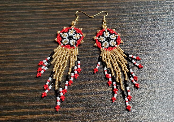 These beautiful Huichol Hand Beaded Fringe Earrings are sure to please. Perfect for that boho style or hippie jewelry. These earrings are for display only. Your earrings will be made to order in the colors of your choice. It usually takes 2-4 days to complete a pair of earrings, but Christmas rush may extend that time by a day or two. ❤ SIZE & DETAILS ♡ Hooks are 22k gold plated fish hook wire. (Hooks can be swapped between silvertone metal fish hook wires, silvertone clip-on or 22k gold plated Traditional Gold Beaded Earrings As Gift, Handmade Round Beaded Earrings For Festivals, Traditional Dangle Jewelry With Bead Caps, Bohemian Drop Earrings With Bead Caps, Handmade Bohemian Beaded Earrings With Adjustable Fit, Bohemian Beaded Earrings With Dangling Beads For Festivals, Red Bohemian Beaded Earrings With Gold Beads, Bohemian Red Beaded Earrings With Gold Beads, Bohemian Jewelry With Bead Caps For Festivals