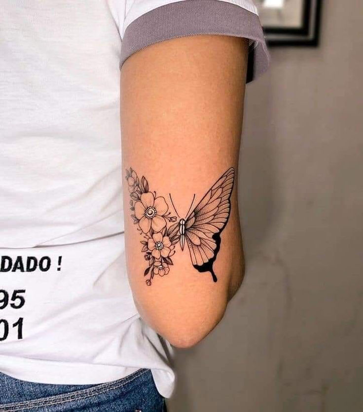 a woman with a butterfly tattoo on her arm