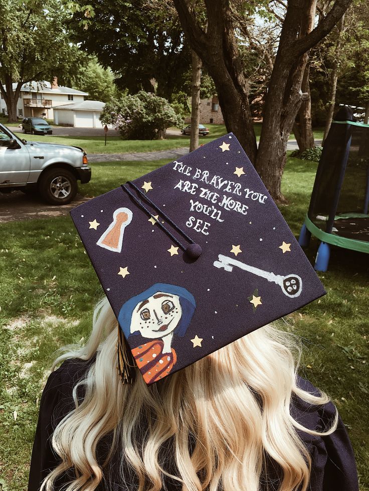 a woman wearing a graduation cap with writing on it