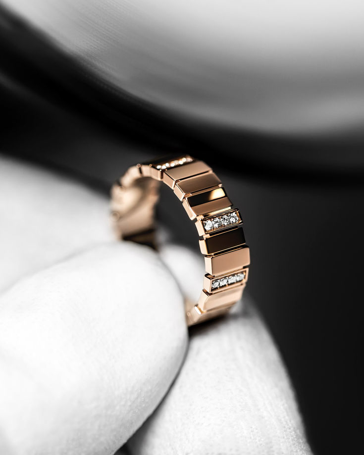 a close up of a person's hand with a ring on it