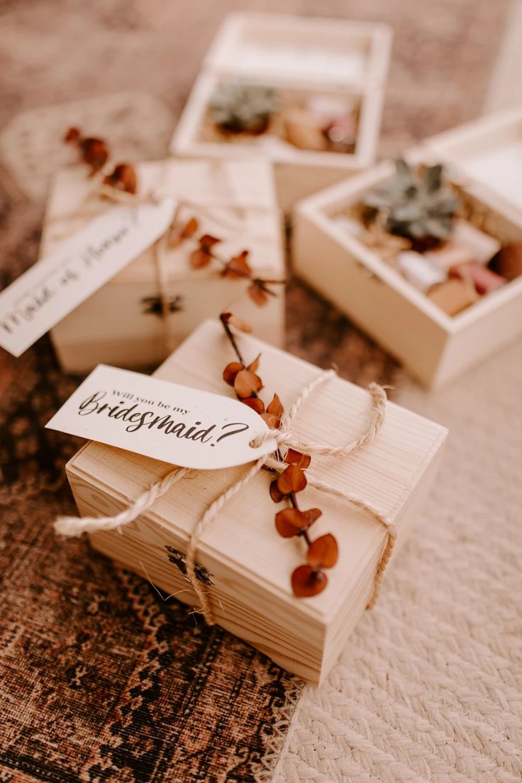 small wooden boxes with tags tied to them on a carpeted floor next to other items