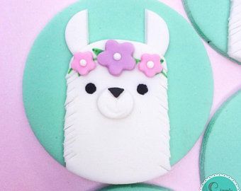 an alpaca decorated with flowers on top of some cookies