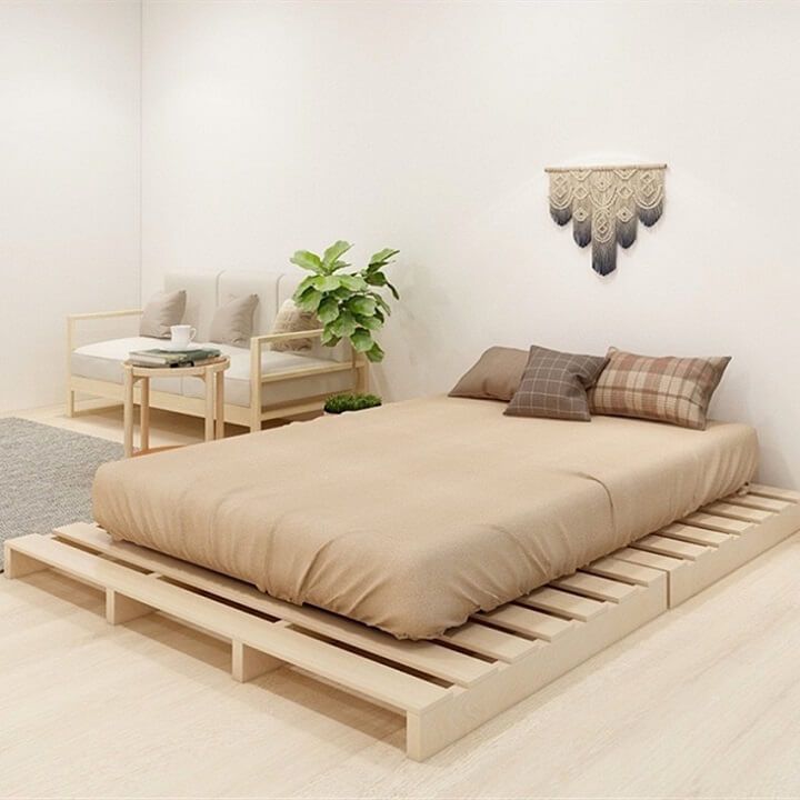 a bed sitting on top of a wooden platform