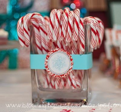 some candy canes are in a glass on a table