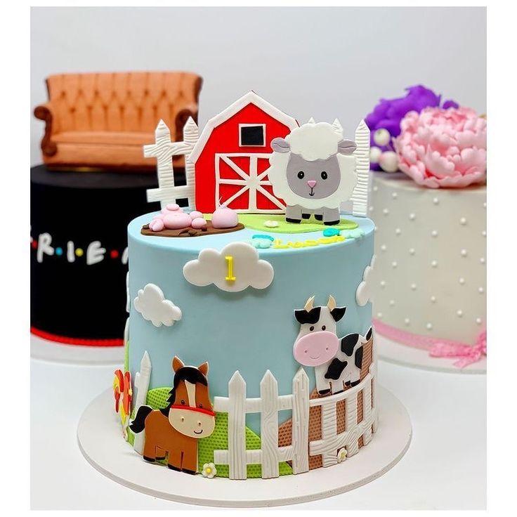 three cakes decorated with farm animals and farm scenes on top of each cake are shown