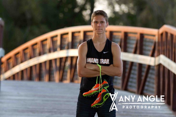 a man standing on a bridge with his arms crossed