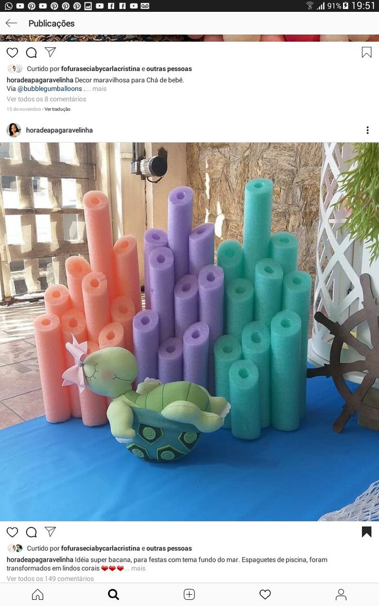 a bunch of candles that are on top of a blue table with an umbrella in the background