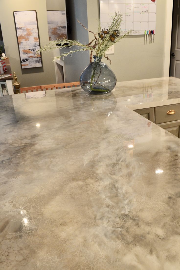 a kitchen counter with a vase filled with flowers