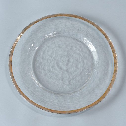 a white plate with gold trim around the edge