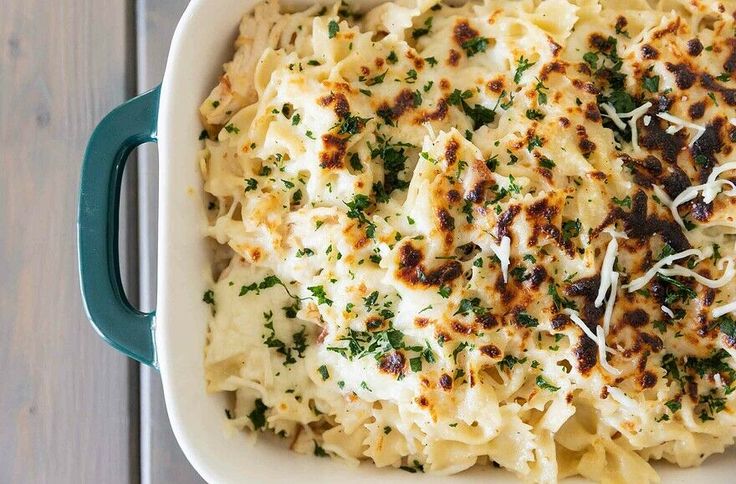 a casserole dish with cheese and parmesan sprinkled on top