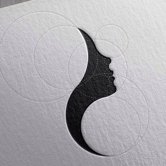 the logo is designed to look like a woman's face with circles around it