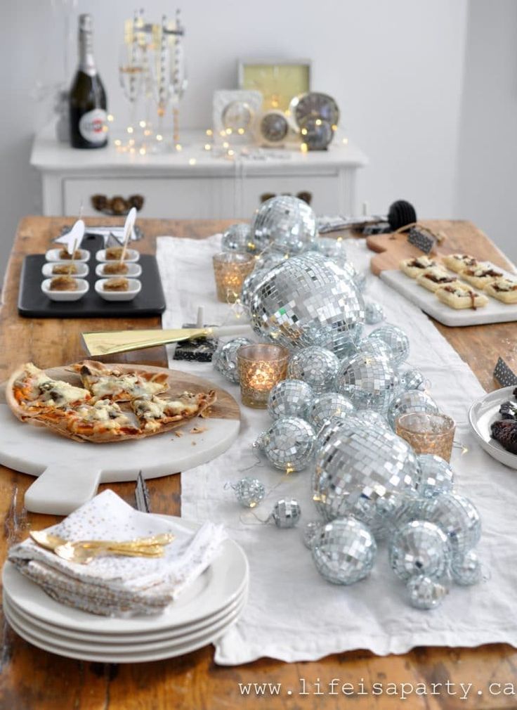 a wooden table topped with plates and pizza