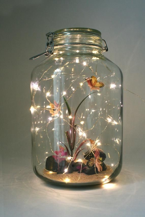 a glass jar filled with rocks and lights