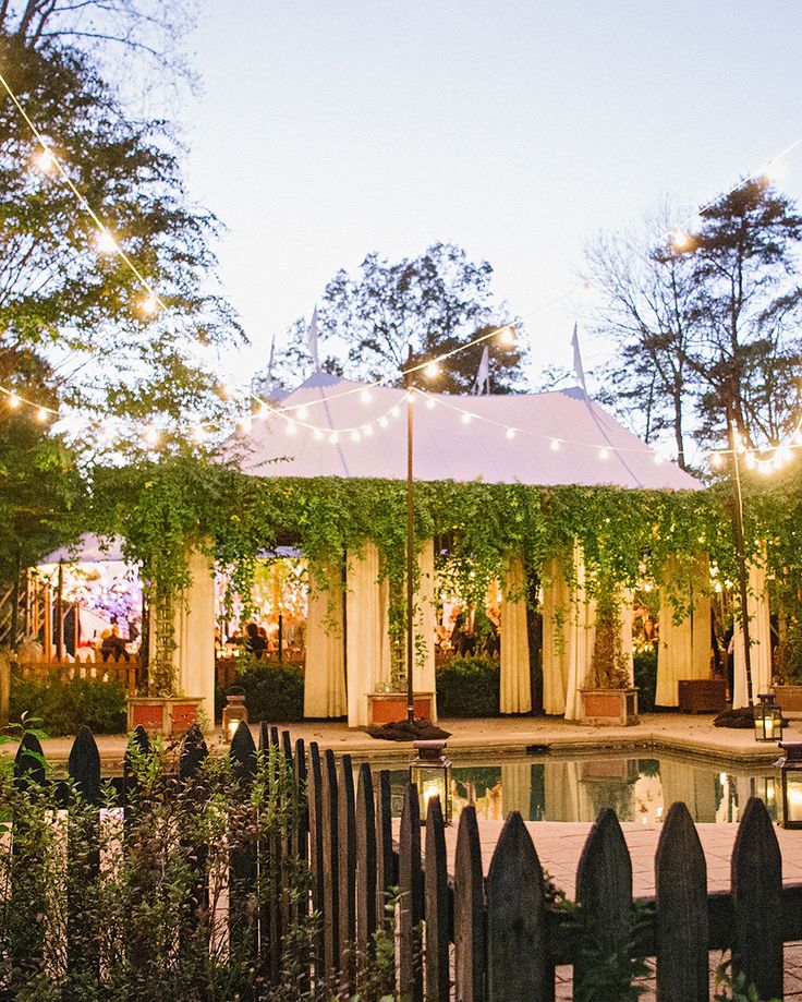 the gazebo is surrounded by greenery and lights