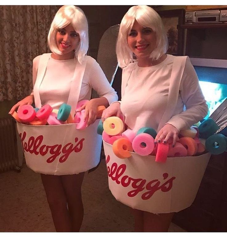 two women dressed in costumes holding doughnuts and donuts with the word's on them