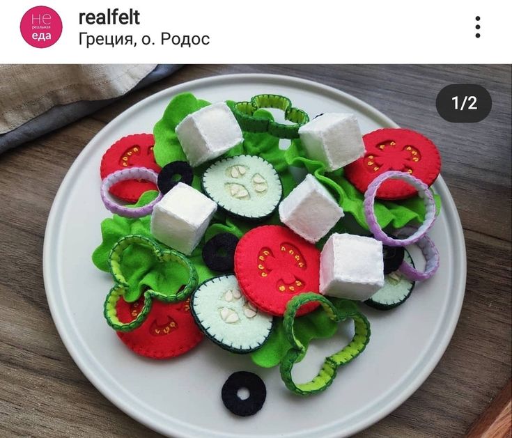 a white plate topped with lots of veggies on top of a wooden table