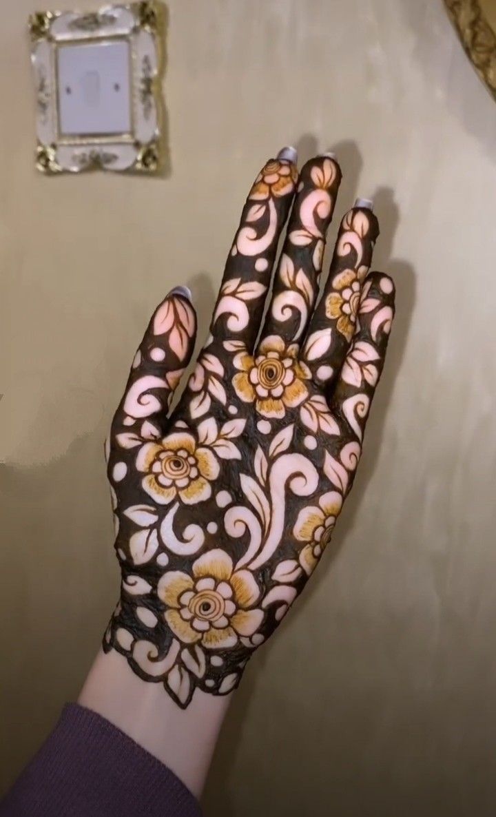 a woman's hand with hendix painted on it next to a light switch