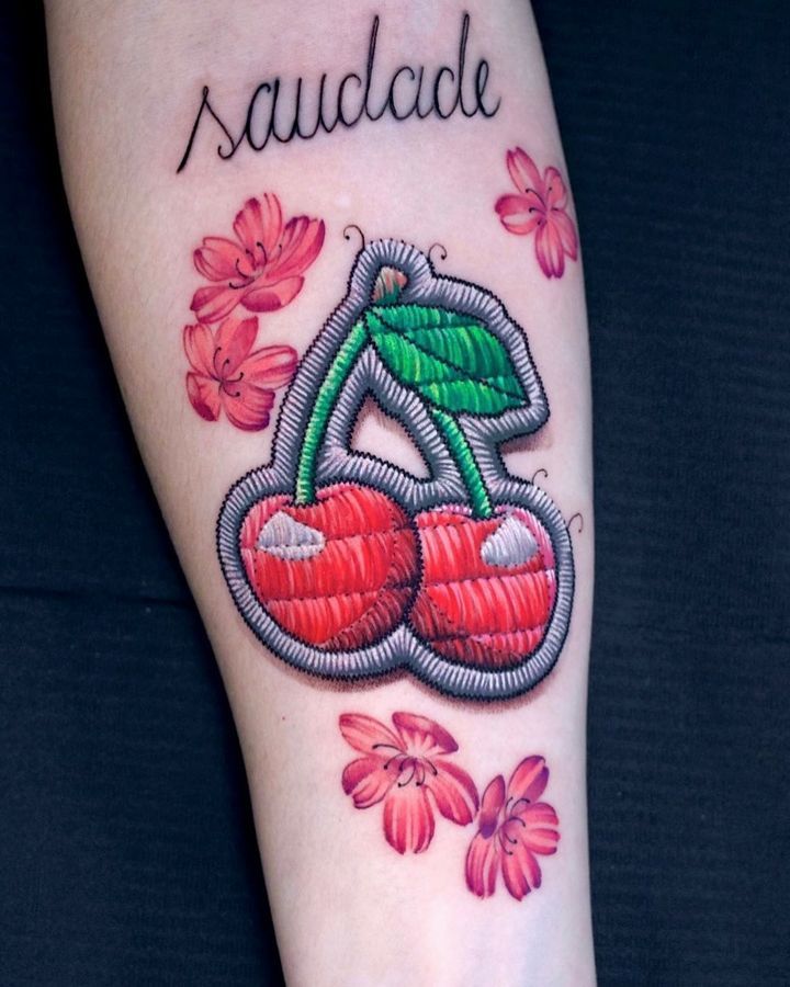 a tattoo with cherries on it and the word saucdae written in cursive writing