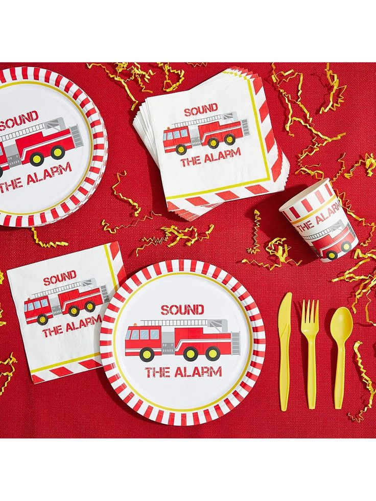 red and white paper plates with firetrucks on them, yellow plastic utensils next to each other