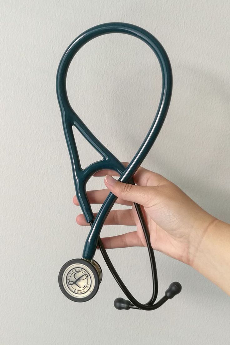 a hand holding a stethoscope in the shape of a doctor's hat