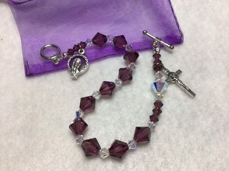 "A beautiful one decade rosary bracelet  made from Swarovski Amethyst and Crystal bicone beads.  Handmade 7 1/2\" bracelet is made with Swarovski 8 mm and 4 mm Amethyst and Crystal beads.   Perfect gift for birthdays, Communion, Confirmation gifts as well as for Mothers Day and Wedding party gifts." Purple Beaded Rosary As Gift, Nickel-free Rosary Bracelet For Gift, Adjustable Purple Rosary Bracelet, Amethyst Rosary, Multicolor Hand-strung Rosary Bracelet Gift, Rosary Bracelet, Confirmation Gifts, Gifts For Wedding Party, Beautiful One