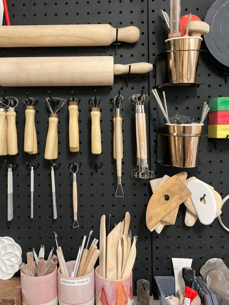 a peg board with various kitchen utensils on it