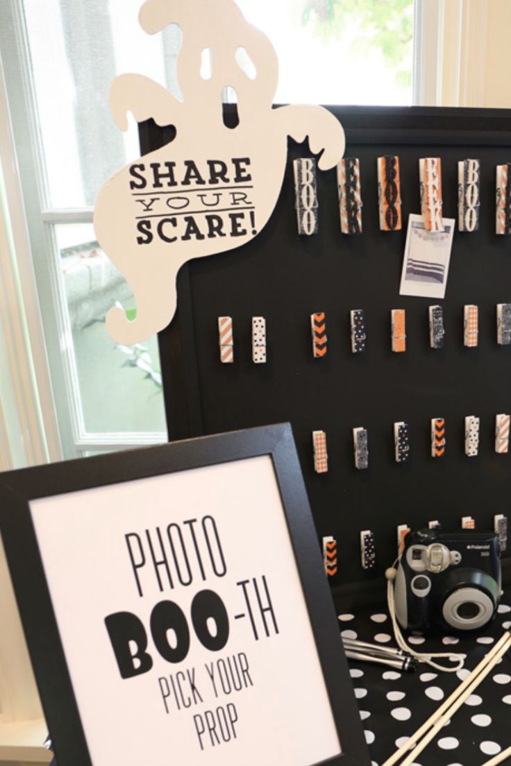 a table topped with black and white polka dot covered items next to a sign that says photo boo - tik your prop