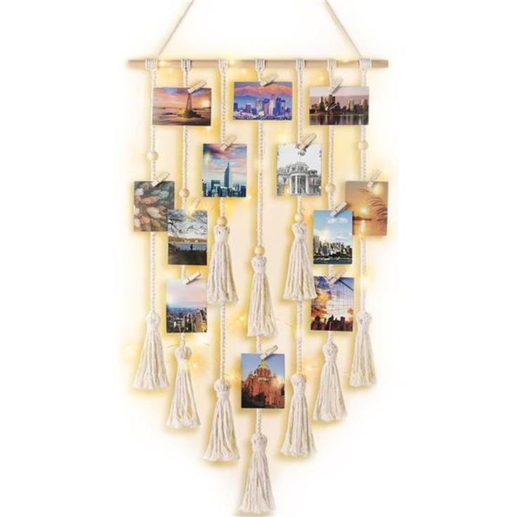 a wall hanging with pictures and tassels attached to the side on a white background