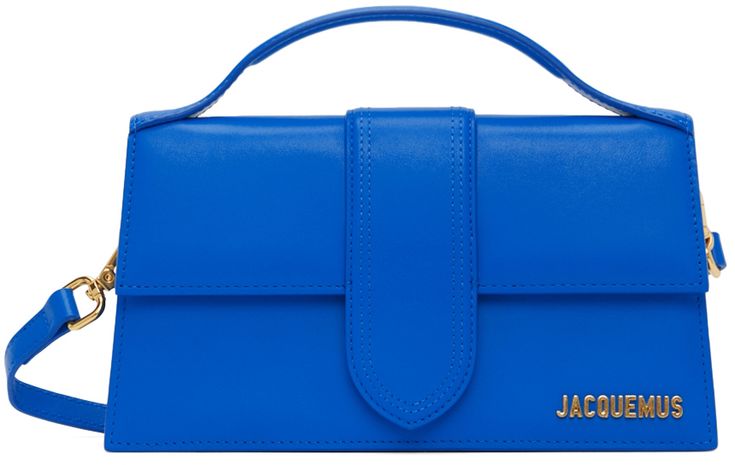 Buffed leather top handle bag in blue. Logo plaque at face. · Carry handle at top · Adjustable and detachable shoulder strap · Patch pocket at back face · Foldover flap with magnetic press-stud closure · Card slot and leather logo patch at interior · Twill lining in beige · Gold-tone hardware · H5 x W9.25 x D2.75 in Part of the La Montagne collection. Supplier color: Blue | Jacquemus Blue La Montagne 'Le Grand Bambino' Bag Blue Bag Outfit, Jacquemus Bags, Jacquemus Bag, Fancy Clothes, Denim Shoulder Bags, Blue Logo, Leather Logo, Types Of Bag, Fancy Outfits