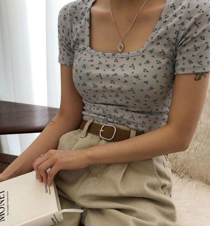 a woman sitting on a bed holding a book