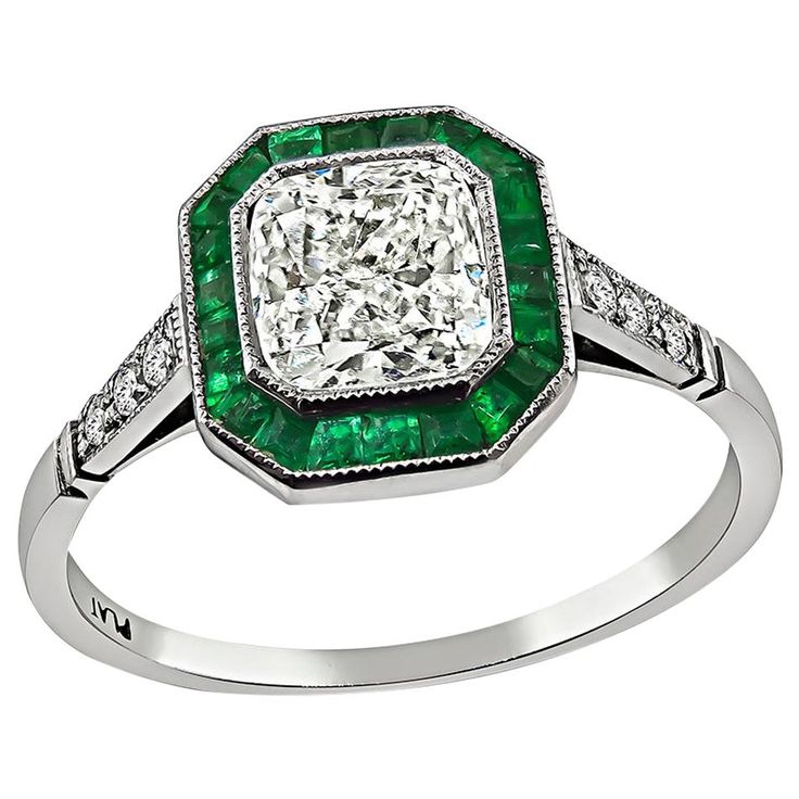 This is an elegant platinum engagement ring inspired from the Art Deco era. The ring is centered with a sparkling radiant cut diamond that weighs approximately 1.01ct. The color of the diamond is I-J with VS clarity. The center diamond is accentuated by lovely emerald and round cut diamond accents. The ring is stamped PLAT and weighs 3 grams. The ring is size 6 1/2 but it can be resized. Inventory #98630PEKS Classic Emerald Ring With Princess Cut Diamond, Classic Princess Cut Emerald Ring With Diamond Detail, Classic Princess Cut Emerald Ring With Halo Setting, Classic Emerald Princess Cut Diamond Ring, Classic Princess Cut Emerald Diamond Ring, Classic Asscher Cut Diamond White Emerald Ring, Classic Cushion Cut Emerald Ring For Formal Occasions, Platinum Emerald Ring With Diamond White Center Stone, Art Deco Emerald Ring With Platinum