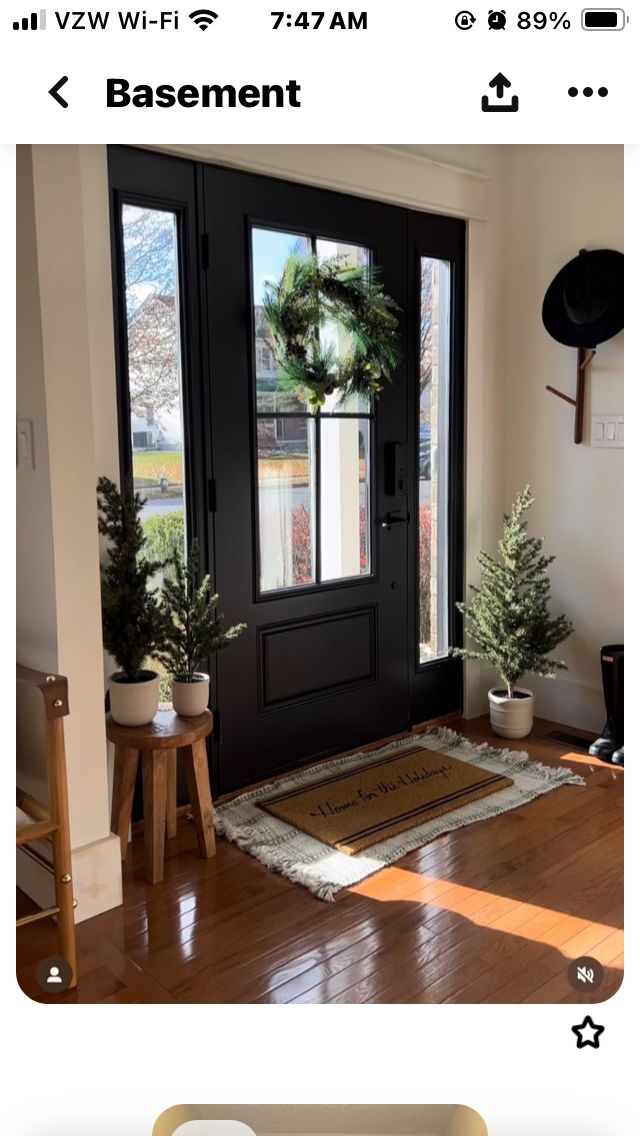 the front door is black and has a wreath on it