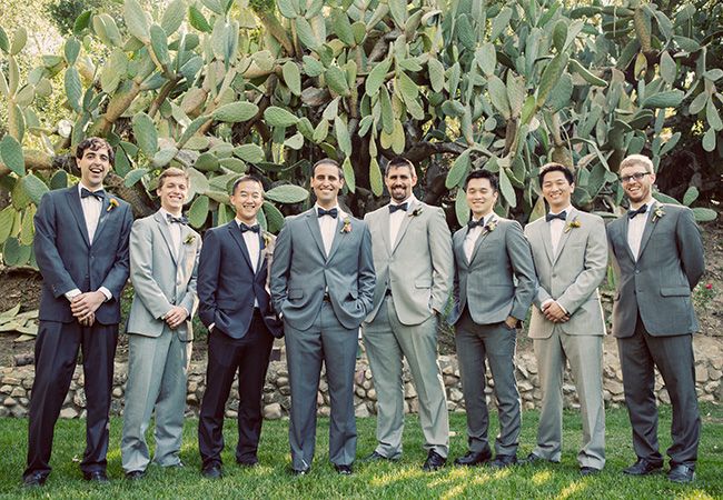 a group of men in suits standing next to each other