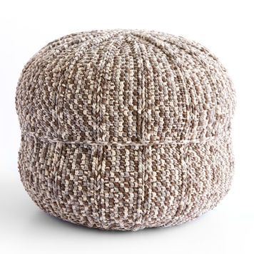 a brown and white tweed poufce sitting on top of a table