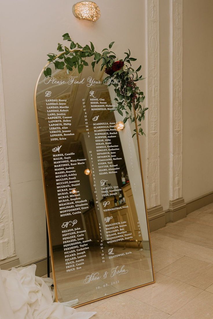 a wedding seating plan on a large mirror