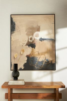 a painting on the wall above a wooden table