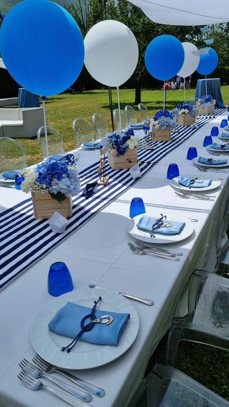 a table set up with blue and white decorations