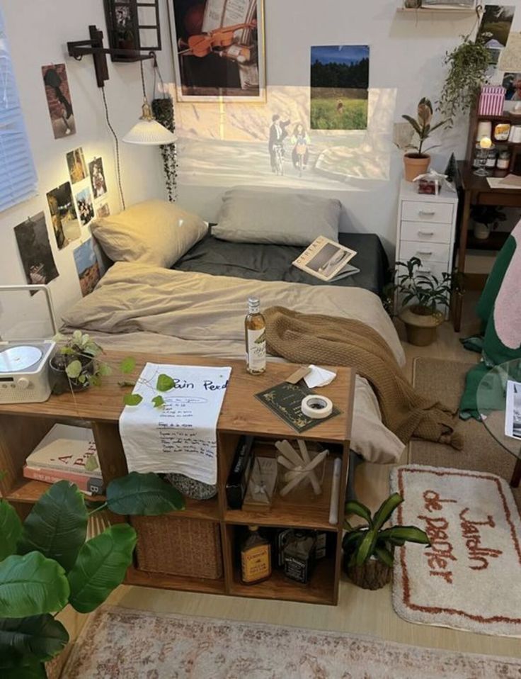 a bed room with a neatly made bed and lots of pictures hanging on the wall