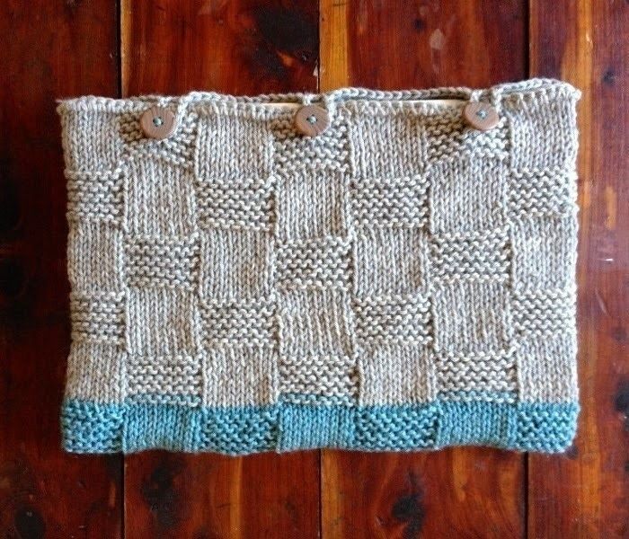 a close up of a knitted bag on a wooden floor