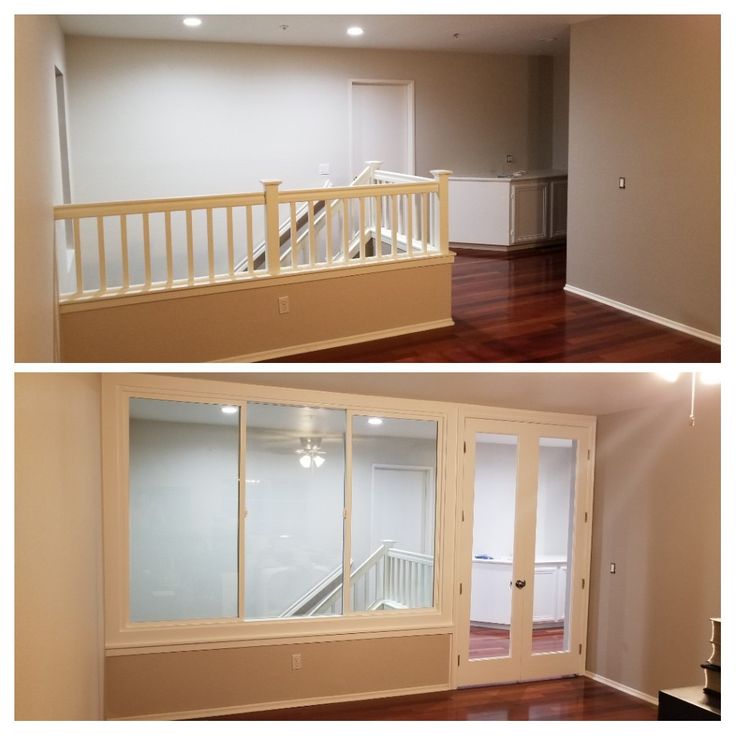 an empty living room with wood floors and sliding glass doors to the second story balcony