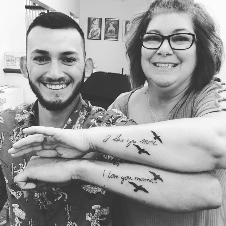 a man and woman with tattoos on their arms